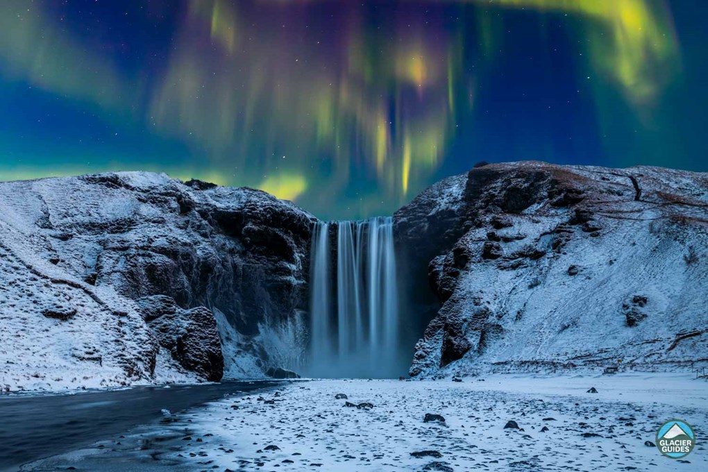 Northern Lights And Skogafoss Waterfall In Snow