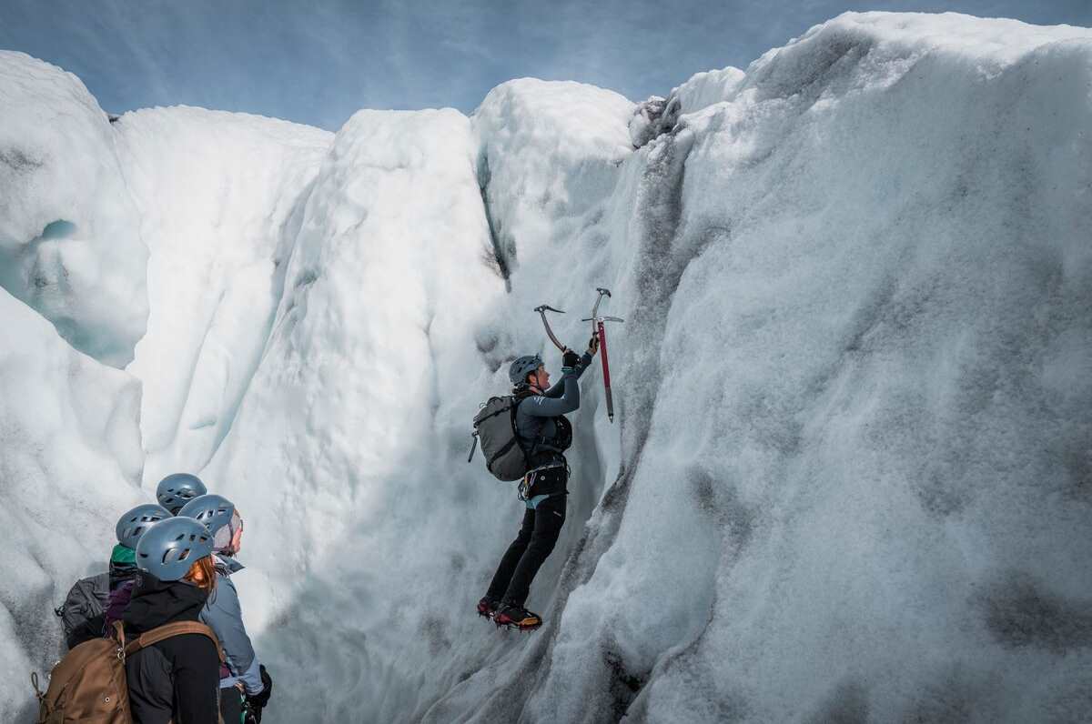 Ice wall climbing at falljokull glacier tour group