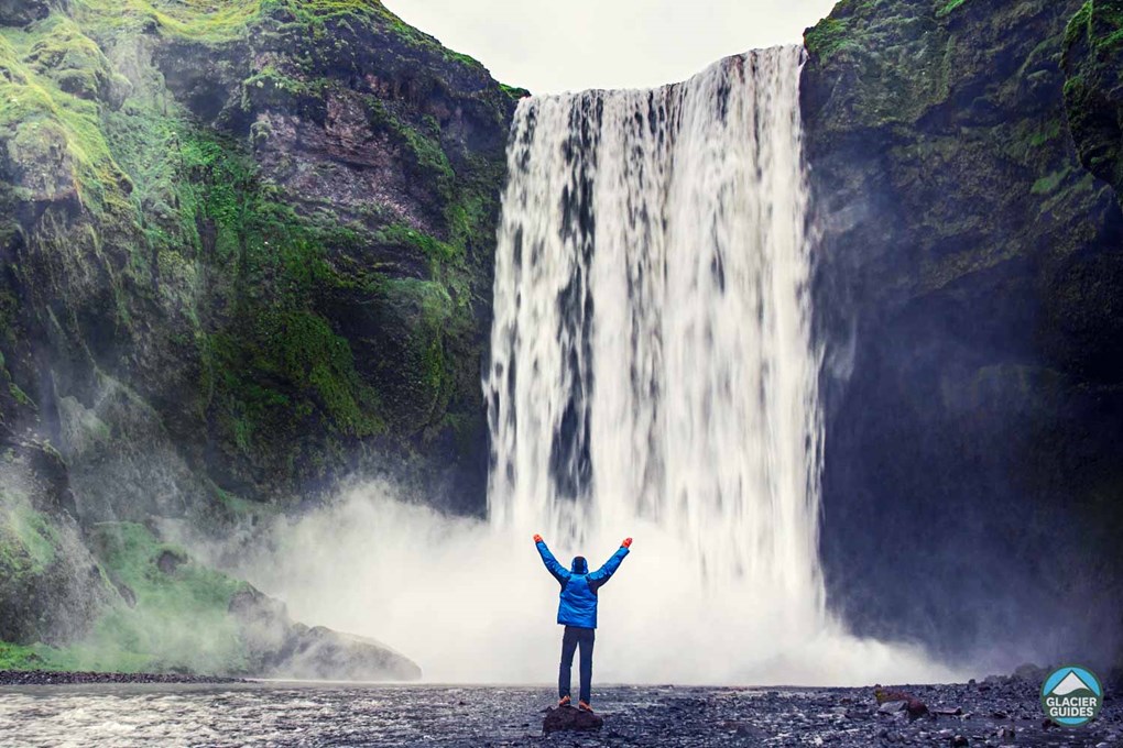 Man On Rock At Skogafoss Waterfall